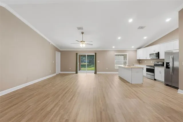 a view of kitchen with wooden floor and electronic appliances