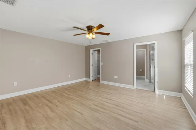 wooden floor in an empty room with a window