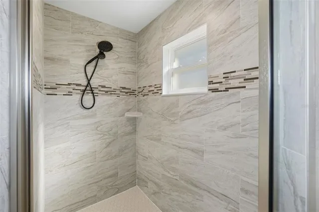 a bathroom with a glass shower door
