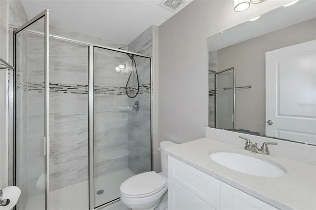 a bathroom with a toilet a sink and shower