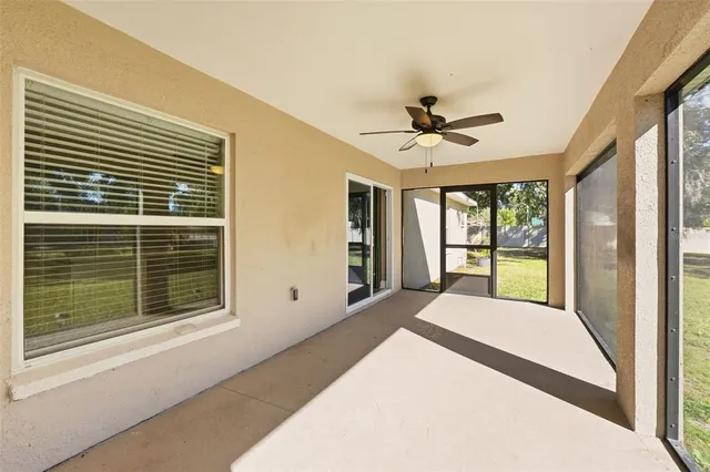 a view of a room with a ceiling fan and a large window
