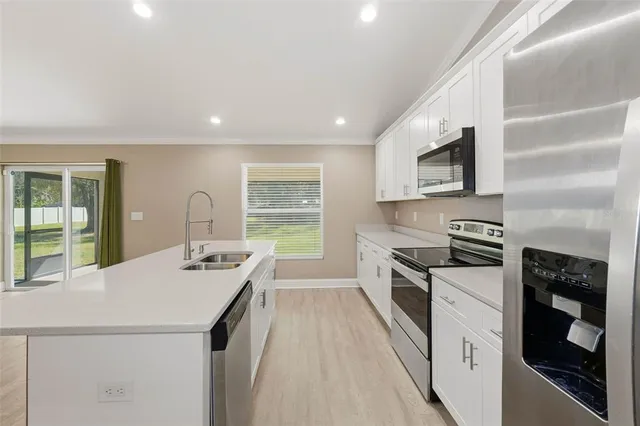 a kitchen with a sink stove and refrigerator
