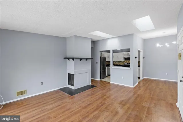 a kitchen with a refrigerator and window
