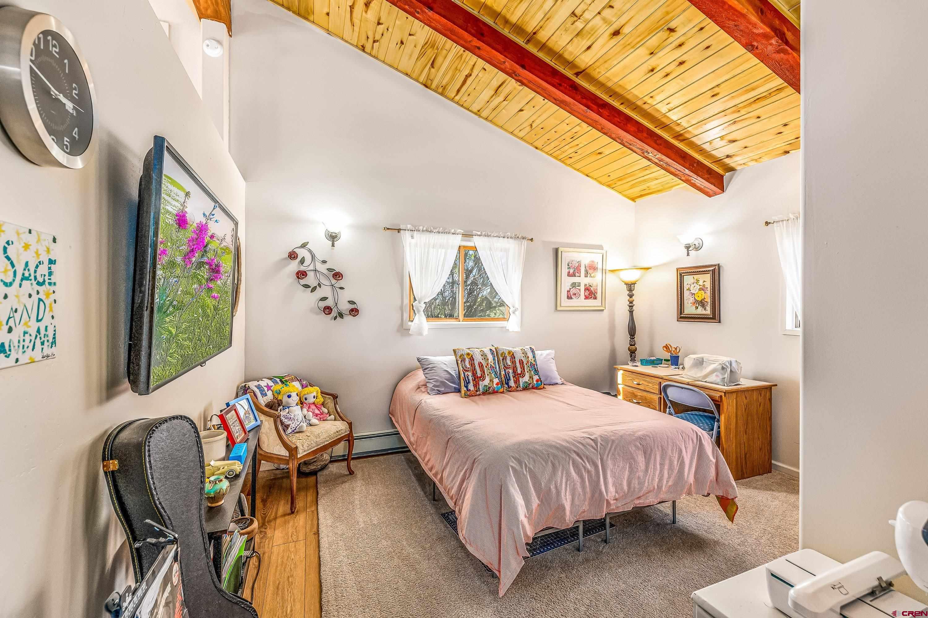 17938 B Road Delta, CO 81416 - Photo 12 of 41 a bedroom with a bed a dresser and next to a window