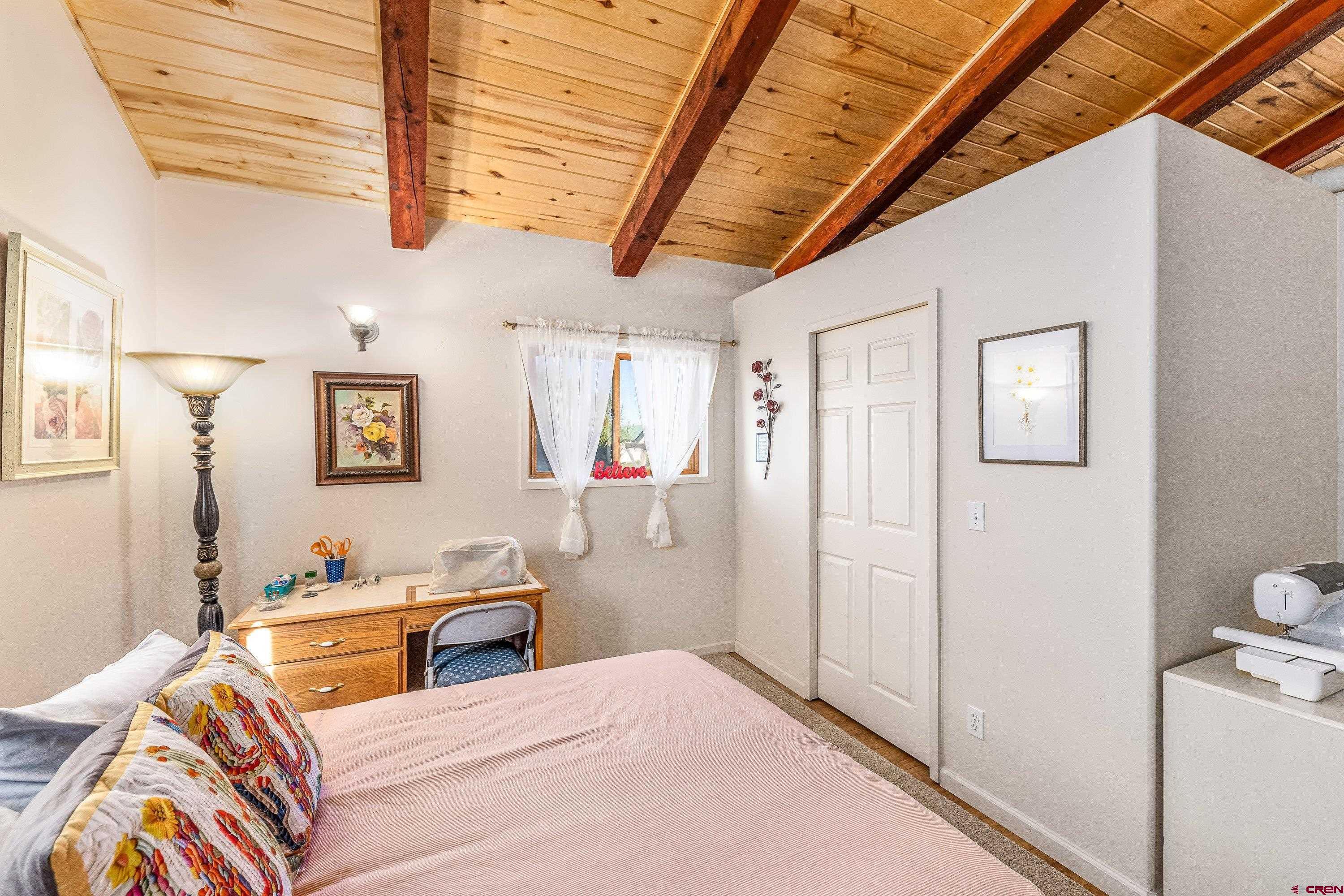 17938 B Road Delta, CO 81416 - Photo 13 of 41 a bedroom with a bed a couch and cabinet