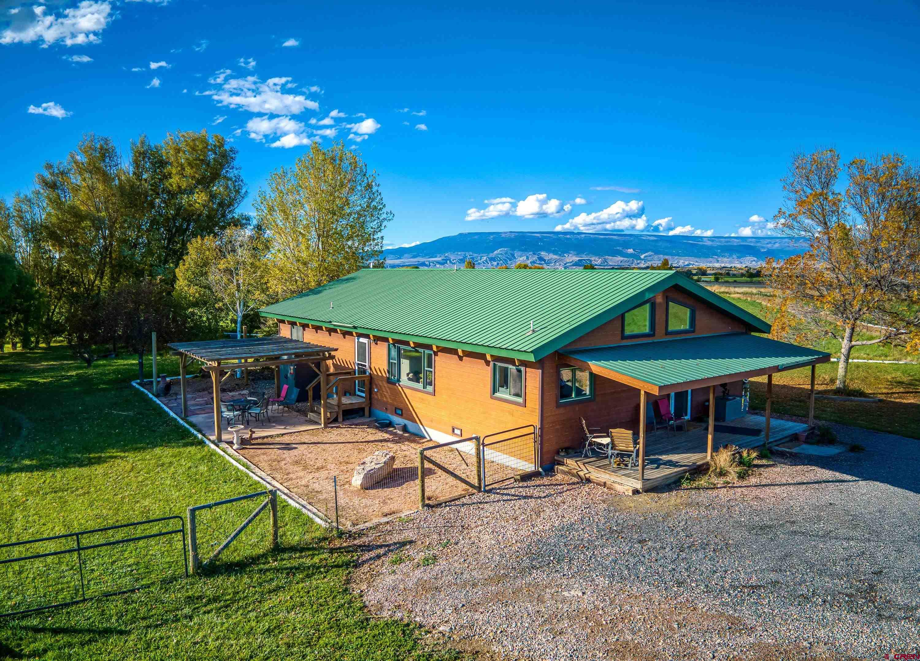 17938 B Road Delta, CO 81416 - Photo 23 of 41 a view of a house with backyard water fountain and sitting area