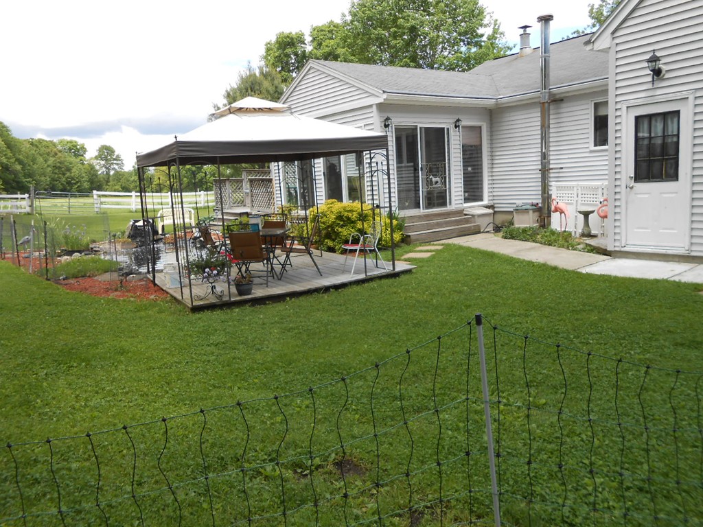 41 Corbin Road Dudley, MA 01571 - Photo 13 of 29 a view of a house with backyard sitting area and garden