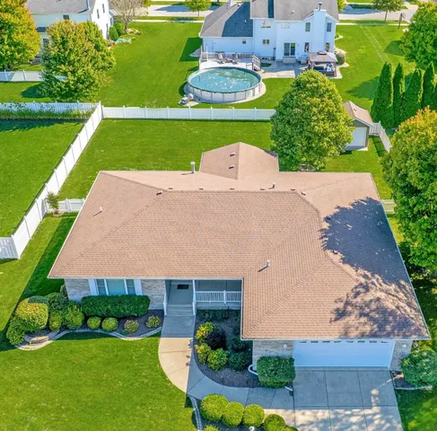an aerial view of a house with swimming pool garden and outdoor seating