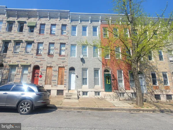 a front view of a building with parking space