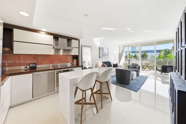 a kitchen with stainless steel appliances kitchen island granite countertop a sink and cabinets