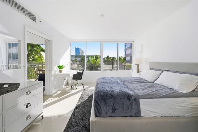 a bed sitting in a bedroom next to a window