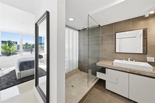 a bathroom with a double vanity sink toilet and shower