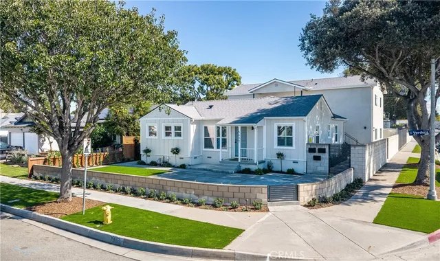 a front view of a house with a garden and swimming pool