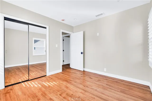 an empty room with wooden floor and door