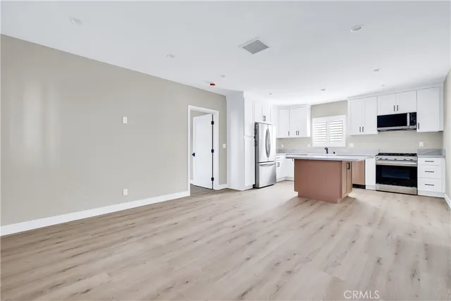 a view of kitchen with wooden floor and fireplace