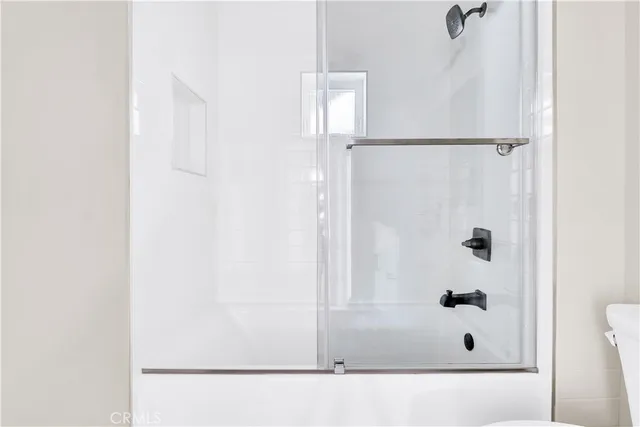 a bathroom with a glass shower door