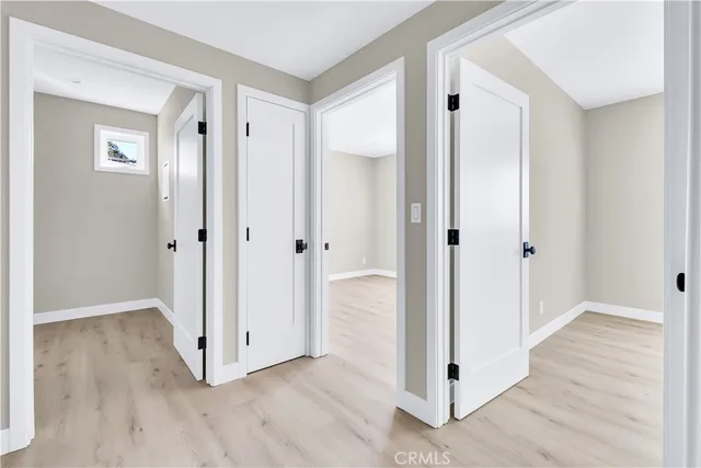 a view of a hallway with wooden floor