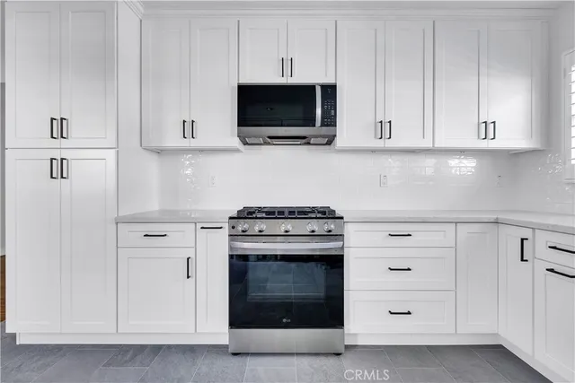 a kitchen with cabinets appliances and a sink