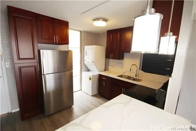 a kitchen with stainless steel appliances a refrigerator stove microwave and sink
