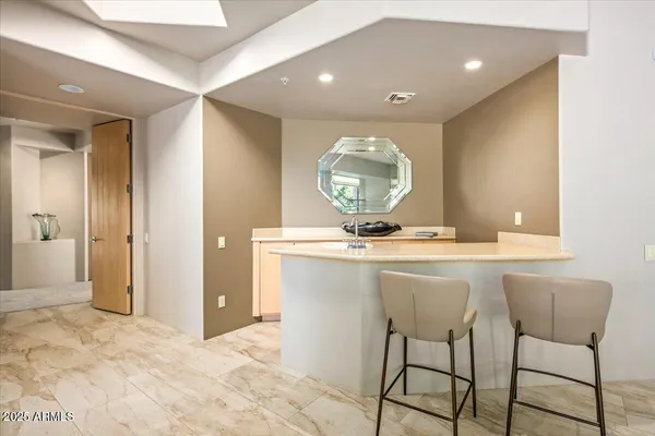 a view of kitchen with stainless steel appliances granite countertop sink and cabinets