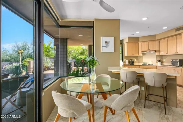 a dining room with furniture and a potted plant