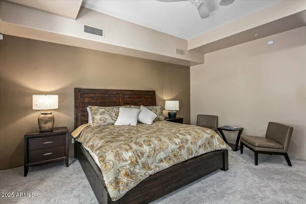 a bedroom with a bed and a chair