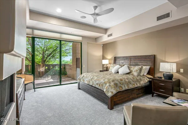 a bedroom with a large bed and a balcony view