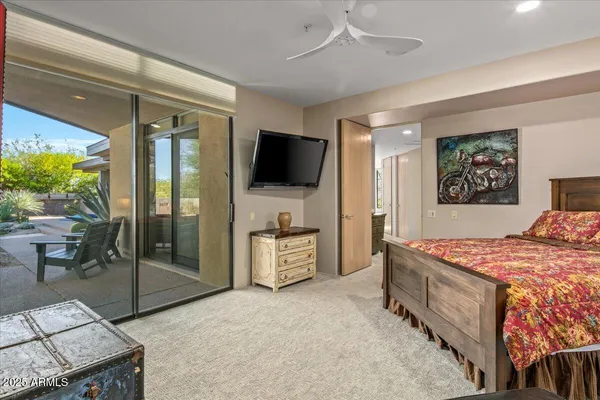 a bedroom with furniture and a flat screen tv