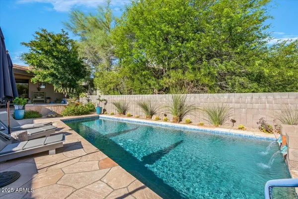 a view of a backyard with sitting area
