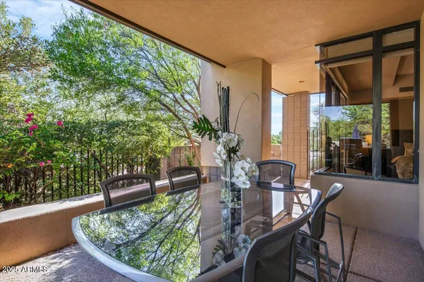 a view of a patio with table and chairs and potted plants