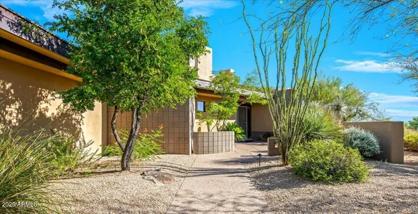 a view of a house with a tree in front