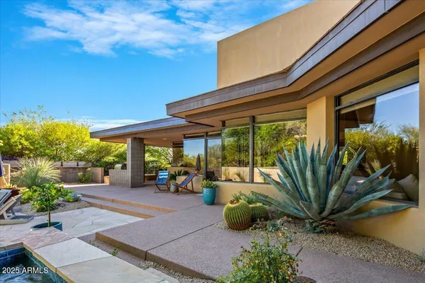 a view of a backyard with plants and patio
