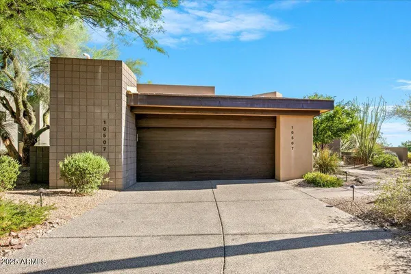 a front view of a house with a garage