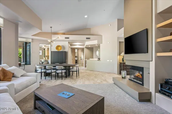 a living room with furniture a fireplace and a flat screen tv