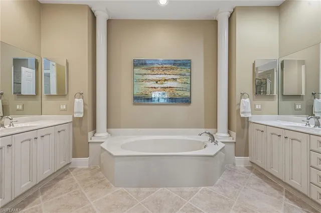 a bathroom with a granite countertop bathtub sink and mirror