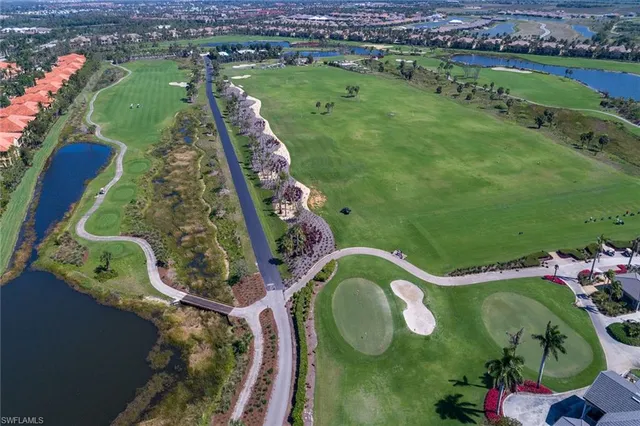 an aerial view of residential houses with outdoor space and lake view