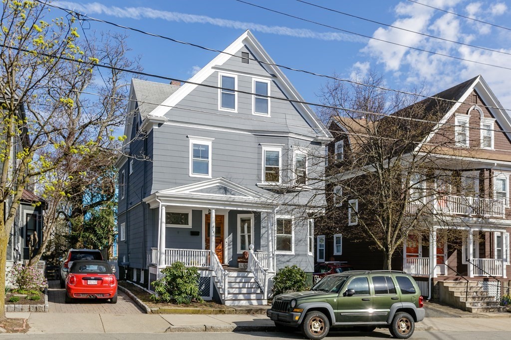 a front view of a residential apartment building with a yard