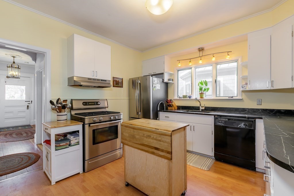 181 Willow Avenue Somerville, MA 02144 - Photo 14 of 31 a kitchen with a stove a sink and a refrigerator