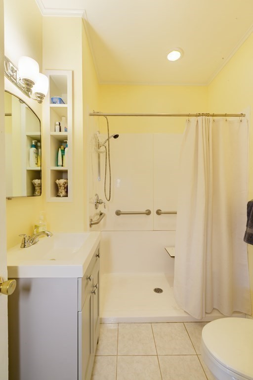 181 Willow Avenue Somerville, MA 02144 - Photo 16 of 31 a bathroom with a granite countertop sink a toilet and shower