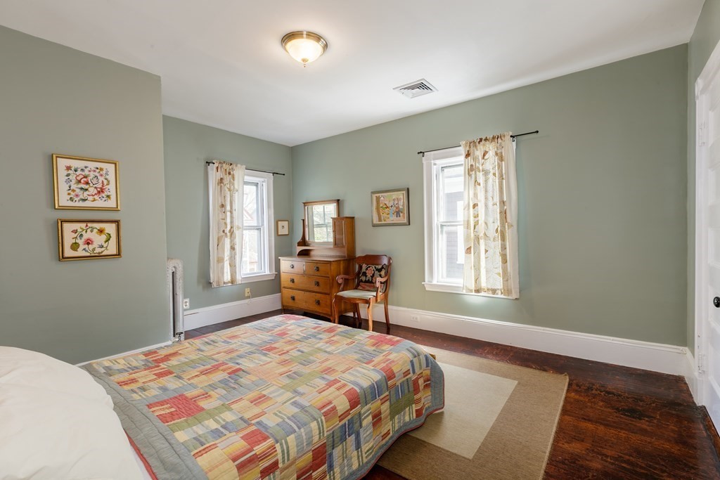 181 Willow Avenue Somerville, MA 02144 - Photo 18 of 31 a bedroom with a bed and a window