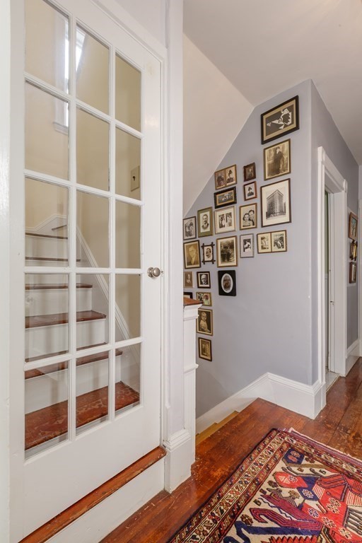 181 Willow Avenue Somerville, MA 02144 - Photo 22 of 31 a view of a bedroom with wooden floor & cabinet