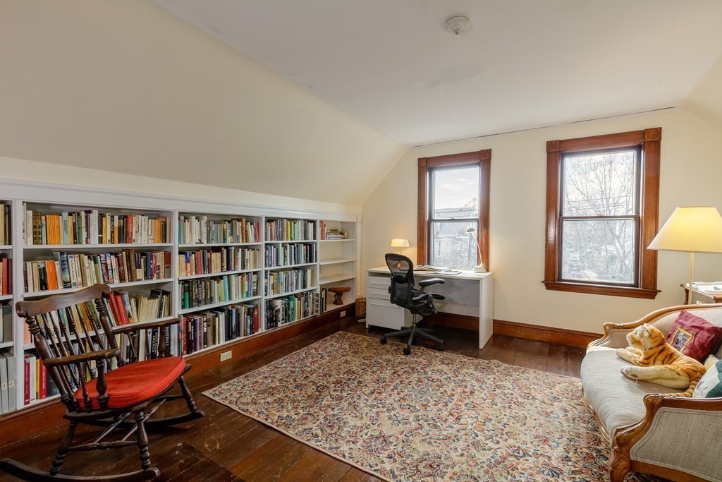 181 Willow Avenue Somerville, MA 02144 - Photo 23 of 31 a living room with furniture and a book shelf