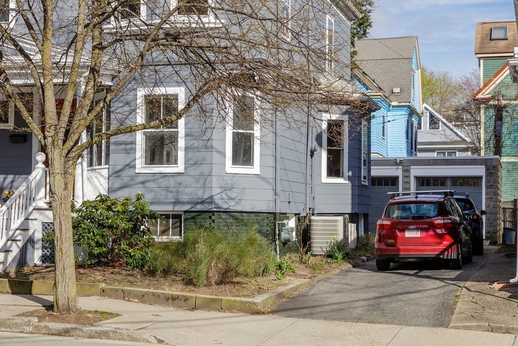 181 Willow Avenue Somerville, MA 02144 - Photo 3 of 31 a car parked in front of a brick house