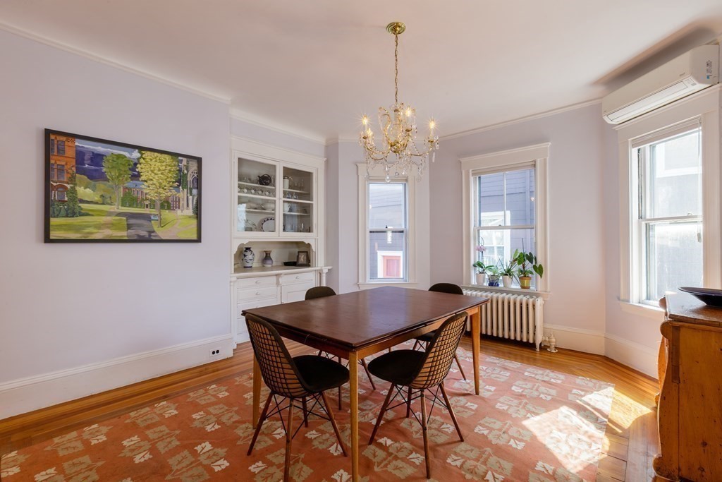 181 Willow Avenue Somerville, MA 02144 - Photo 9 of 31 a view of a dining room with furniture a chandelier and wooden floor