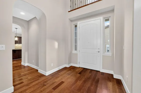 a kitchen with kitchen island granite countertop a stove oven and a wooden floors