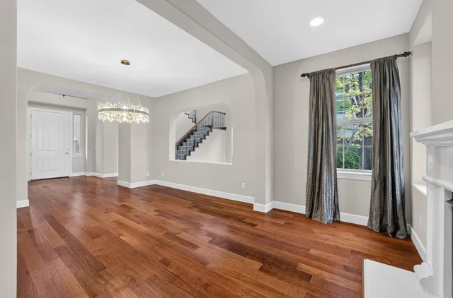 a large kitchen with granite countertop a large counter top space a sink stainless steel appliances and cabinets