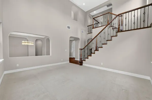 a view of empty room with wooden floor and fireplace