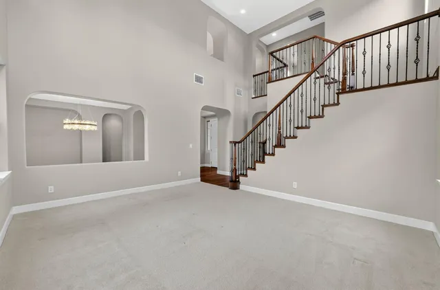 a view of empty room with wooden floor and fireplace