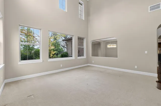 a view of a livingroom with wooden floor and a kitchen