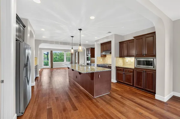 a room with wooden floor and windows